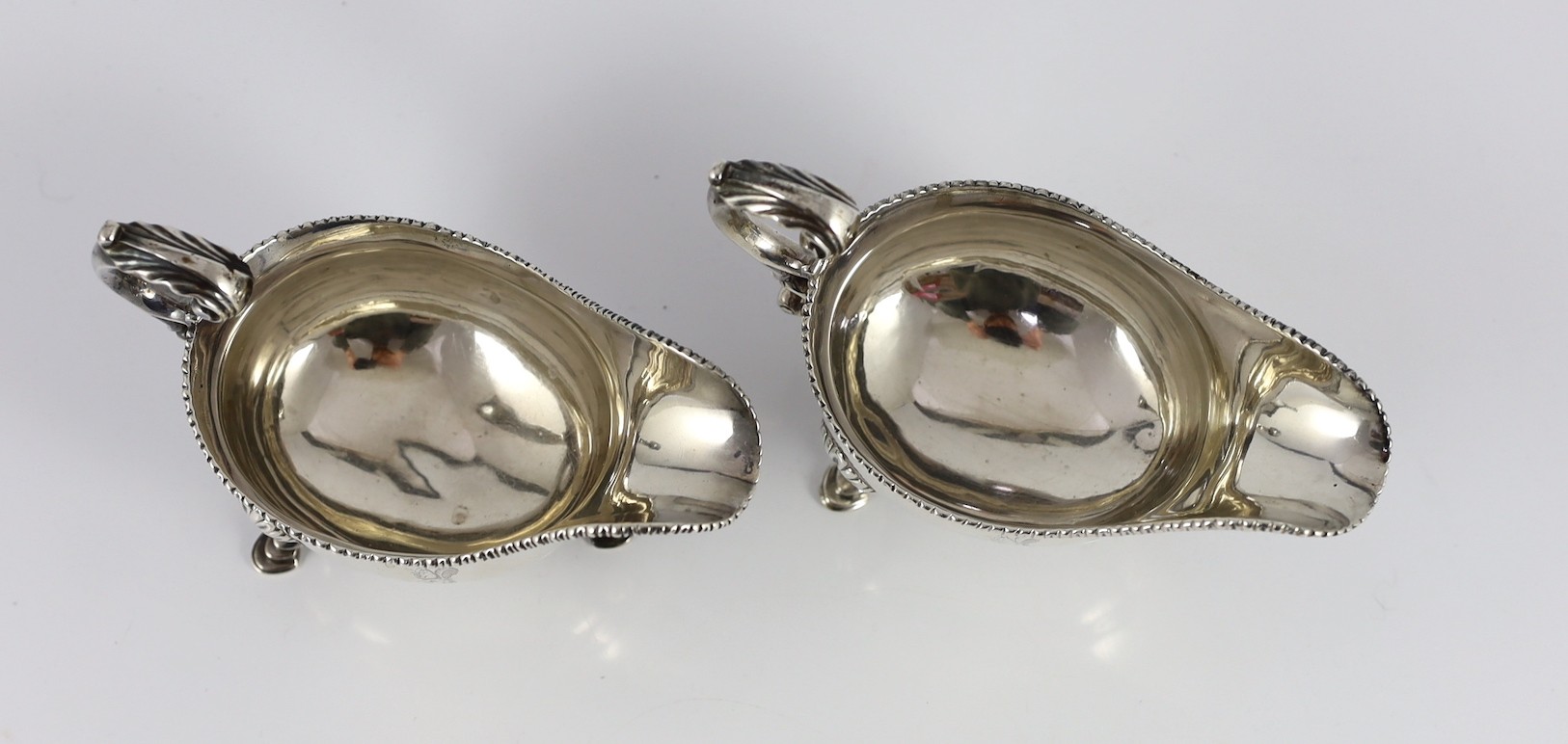 A near pair of George III silver sauceboats